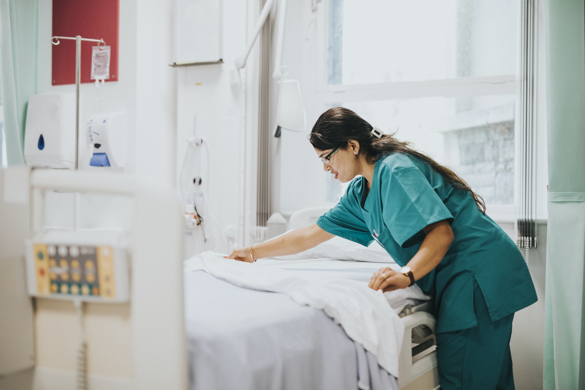 Nurse making the bed at a hospital